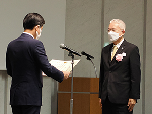 古賀厚生労働副大臣から表彰状を授与される成田浩人氏